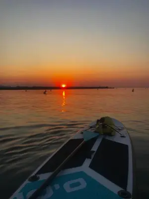 a boat in the water with a sunset in the background at Barcelona's Gem in Barcelona
