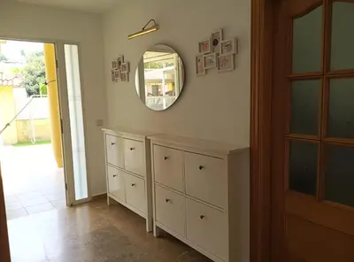 a room with a mirror and a dresser and a door at Brad House in Can Trabal