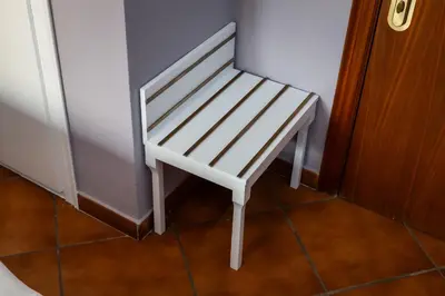 a white stool sitting in the corner of a room at Hotel La Sagrera in Sant Fruitos de Bages