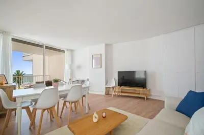 a living room with a couch and a table at Sunset Beachfront in Sitges in Sitges