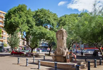 a fountain in a park with people standing around it at Sweett - Charming in Sant Gervasi in Barcelona