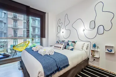 a bedroom with a large bed and a window at Sweett - Calabria in Barcelona
