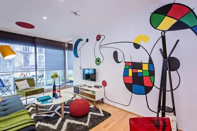 a living room with a large painting on the wall at Sweett - Calabria in Barcelona
