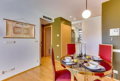 a dining room with a glass table and red chairs at Sweett - Calabria in Barcelona