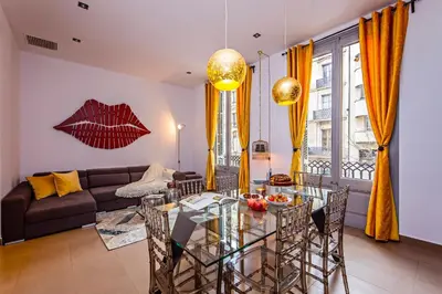 a living room with a glass table and a couch at Sweett - Urqui City Center in Barcelona