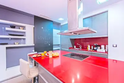 a colorful kitchen with a red counter top at Sweett - Urqui City Center in Barcelona
