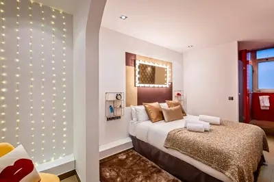 a bedroom with a bed with lights on the wall at Sweett - Urqui City Center in Barcelona