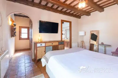 a kitchen with wooden cabinets and a stainless steel refrigerator at Charming Villa Tamarindo in Olivella