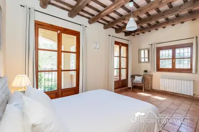 a bedroom with a bed and a flat screen tv at Charming Villa Tamarindo in Olivella