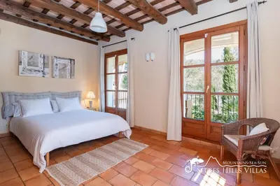 a bathroom with two sinks and a wooden door at Charming Villa Tamarindo in Olivella