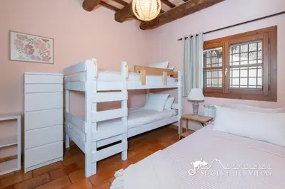 a bedroom with two bunk beds and a bed at Charming Villa Tamarindo in Olivella