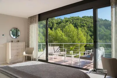 a large kitchen with white counter tops and appliances at Villa Valentino Modern Villa with heated pool in Olivella
