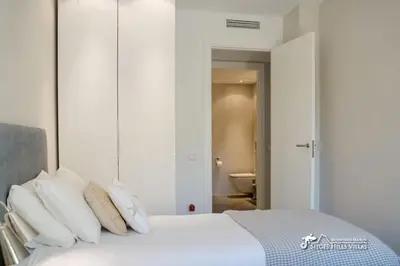a bathroom with a sink and a toilet and a mirror at Villa Valentino Modern Villa with heated pool in Olivella