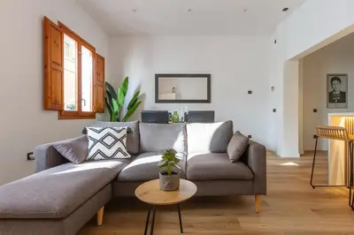 a living room with a couch and a table at Stylish Apartment by the Sea in Sitges