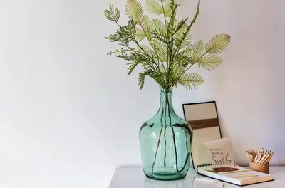a glass vase with a plant in it on a table at Sweett - Loft Villa Olimpica Beach in Barcelona