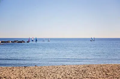 a beach with boats in the water and a group of sailboats at Sweett - Loft Villa Olimpica Beach in Barcelona
