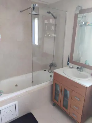 a bathroom with a tub and a sink and a shower at Vilanova Beach Stay in Vilanova i la Geltrú