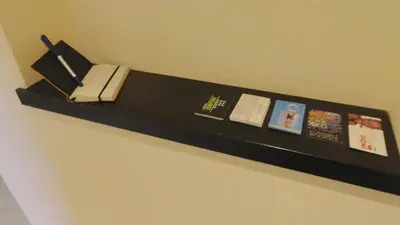 a black shelf with a phone and pictures on it at Apartamento zona playa de San Sebastian in Sitges