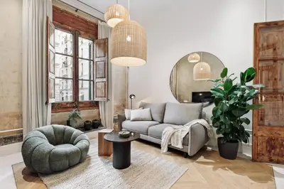 a living room with a couch and a chair at Reus - 1 bedroom in Ciutat Vella in Barcelona
