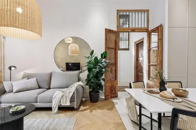 a bedroom with a large bed and a bath tub at Reus - 1 bedroom in Ciutat Vella in Barcelona