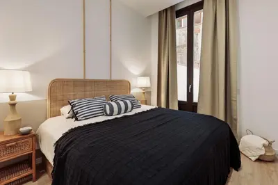 a dining room and living room with a table and chairs at Capaccio - 2 bedrooms and terrace in Ciutat Vella in Barcelona