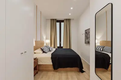a kitchen with white cabinets and a sink at Capaccio - 2 bedrooms and terrace in Ciutat Vella in Barcelona