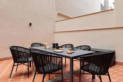 a group of chairs and a table in a room at Capaccio - 2 bedrooms and terrace in Ciutat Vella in Barcelona
