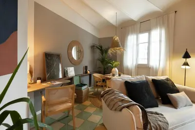 a bedroom with a bed and a chandelier at Bawah - 2 bedrooms in Eixample Esquerra in Barcelona