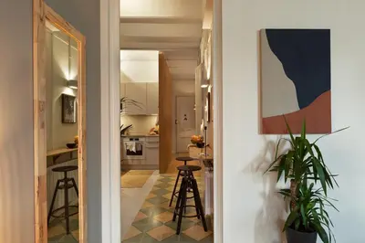 a living room with a white couch and a table at Bawah - 2 bedrooms in Eixample Esquerra in Barcelona