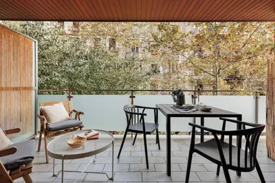 a patio with a table and chairs and a window at Liang - 3 bedrooms in Eixample Esquerra in Barcelona