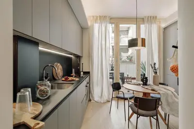 a kitchen with a sink and a table with chairs at Asmali - 2 bedrooms and terrace in Sant Pere in Barcelona