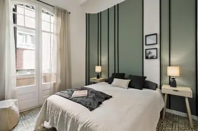 a bedroom with a black cabinet and a mirror at Pegaso - 2 bedrooms and terrace in Sant Gervasi in Barcelona