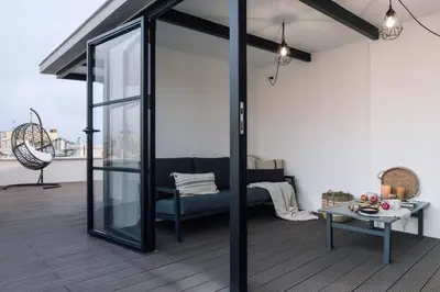 a gazebo on a roof with a couch on a deck at Afrera - 2 bedrooms and terrace in Sant Gervasi in Barcelona