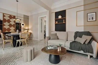 a living room with a table and chairs at Maslak - 2 bedrooms in Eixample Antiga in Barcelona