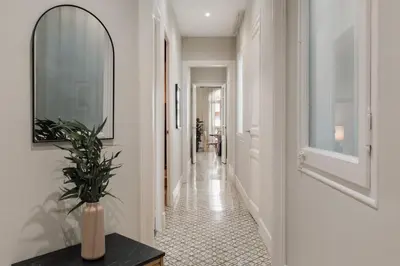 a living room with a table and chairs at Maslak - 2 bedrooms in Eixample Antiga in Barcelona