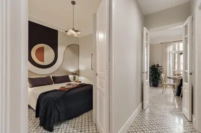 a small bedroom with a bed and a lamp at Maslak - 2 bedrooms in Eixample Antiga in Barcelona