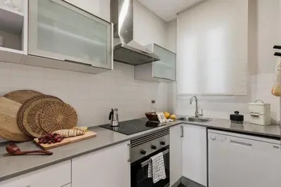 a room with a desk and a table with a chair at Maslak - 2 bedrooms in Eixample Antiga in Barcelona