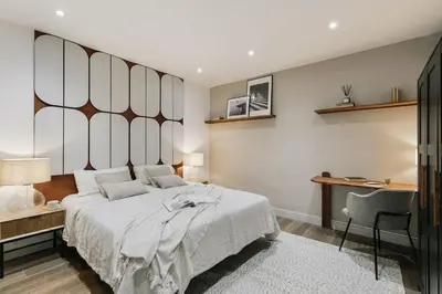 a bed with two lamps and a book on it at Canneti - 3 bedrooms in Sagrada Família in Barcelona