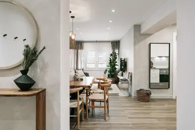 a white bedroom with a bed and a mirror at Canneti - 3 bedrooms in Sagrada Família in Barcelona