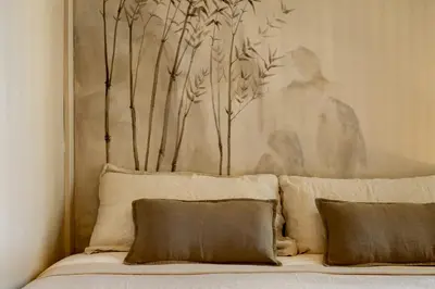 a bed with two pillows and a painting on the wall at Takari - 1 bedroom and balcony in Gràcia in Barcelona