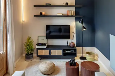 a bedroom with a bed and a desk and a lamp at Takari - 1 bedroom and balcony in Gràcia in Barcelona