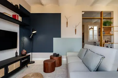 a living room with a couch and a kitchen at Takari - 1 bedroom and balcony in Gràcia in Barcelona