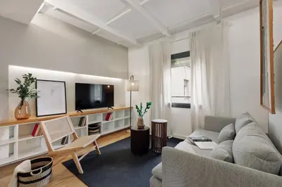 a white bedroom with a bed with a tray on it at Celoni - 1 bedroom and office in Sagrada Família in Barcelona