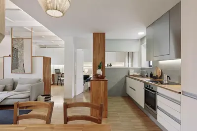 a living room with a couch and a bedroom at Celoni - 1 bedroom and office in Sagrada Família in Barcelona