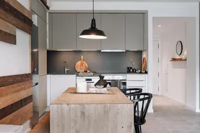 a living room with a table and a kitchen at Viella - 3 bedrooms in Eixample Esquerra in Barcelona