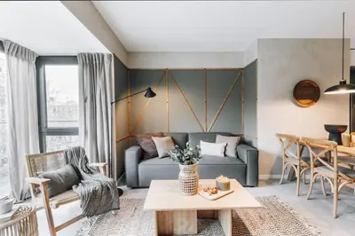 a bedroom with a bed and a table with a lamp at Sare - 3 bedrooms in Eixample Esquerra in Barcelona