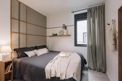 a bedroom with a large bed with two lamps at Sare - 3 bedrooms in Eixample Esquerra in Barcelona