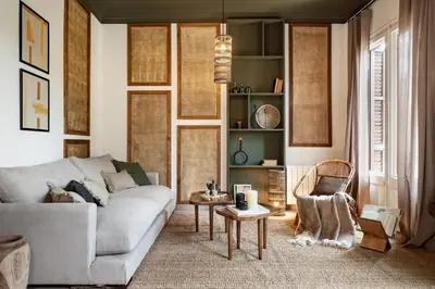 a living room with a couch and a chair at Lendu - 2 bedrooms and balcony in Sant Antoni in Barcelona