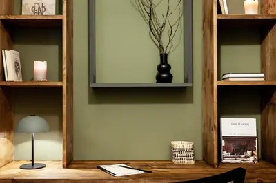 a chair in a room with a desk and shelf at Lendu - 2 bedrooms and balcony in Sant Antoni in Barcelona