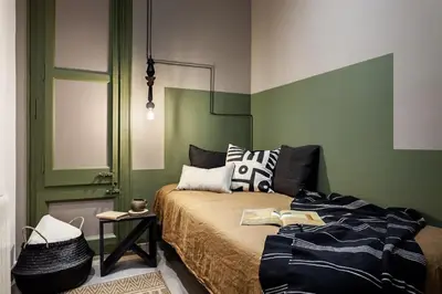 a bedroom with a bed and a green wall at Lendu - 2 bedrooms and balcony in Sant Antoni in Barcelona